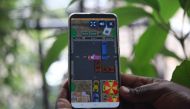 A mobile phone user plays Jam Nomo, a new game by Kenya-based firm Usiku Games, in Nairobi, Kenya on Dec 5, 2019. Thomson Reuters Foundation/Nita Bhalla
