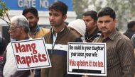 Demonstrators hold placards to protest against the alleged rape and murder of a 27-year-old veterinary doctor in Hyderabad, during a demonstration in New Delhi on December 6, 2019. AFP / Prakash Singh 