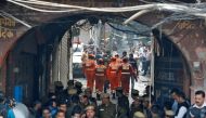 Members of India's National Disaster Response Force (NDRF) head towards the site of a fire that swept through a factory where laborers were sleeping, in New Delhi, India December 8, 2019. REUTERS/Adnan Abidi
