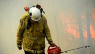 A NSW Rural Firefighter establishes a backburn during bushfires in Mangrove Mountain, New South Wales, Australia, December 8, 2019. AAP Image/Jeremy Piper/via Reuters