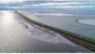 This handout aerial photograph taken on November 19, 2018, and made available by the Rijkswaterstaat (part of the Dutch Ministry of Infrastructure and the Environment) shows a view of the Houtribdijk near Enkhuizen, northern Netherlands, a major dike whic