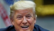 President Donald Trump laughs as he speaks while participating in a 