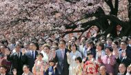 In this file photo taken on April 13, 2019, Japanese Prime Minister Shinzo Abe (centre L) and his wife Akie (center R) pose for pictures with their guests during his cherry blossom viewing party at a park in Tokyo. - Japan OUT / AFP / JIJI PRESS / STR 