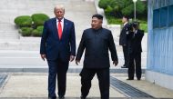 (FILES) In this file photo taken on June 30, 2019, North Korea's leader Kim Jong Un and US President Donald Trump cross south of the Military Demarcation Line that divides North and South Korea, after Trump briefly stepped over to the northern side, in th