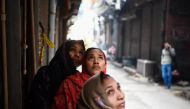  Women look at a factory site where a fire broke out a day before, in Anaj Mandi area of New Delhi on December 9, 2019. AFP / Sajjad Hussain
 