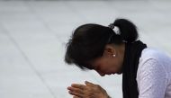This file photo taken on July 19 2016 shows Myanmar State Counsellor Aung San Suu Kyi paying her respects to her late father Myanmar independence hero General Aung San during a ceremony in Yangon. AFP / Ye Aung