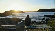Michael Parsons watches the sunrise from Back Beach, Little Bay Islands, Canada, November 2, 2019. Photo handout by Michael Parsons