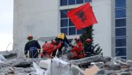 Emergency personnel put an Albanian flag on top of rubble on the occasion of the Albanian Independence Day during a search for earthquake survivors, November 28, 2019. Reuters / Florion Goga