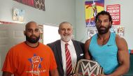 Erwin Singh Braich (c) with wrestlers Jinder Mahal and Arjan Bhullar at their Akhara gym in Richmond.  Facebook /   @IMMEnter