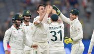 Australia's Pat Cummins (C) celebrates the wicket of New Zealand's Colin de Grandhomme on day four of the first Test cricket match between Australia and New Zealand at the Perth Stadium in Perth on December 15, 2019. (AFP / PETER PARKS)
