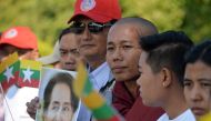 The Supporters of Myanmar's State Counselor Aung San Suu Kyi line up the street for her arrival from Naypyidaw International Airport to Naypyidaw on December 14, 2019. AFP / Thet Aung 