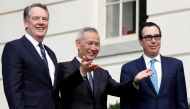 FILE PHOTO: China's Vice Premier Liu He gestures to the media between U.S. Trade Representative Robert Lighthizer (L) and Treasury Secretary Steve Mnuchin before the two countries' trade negotiations in Washington, U.S., October 10, 2019. REUTERS/Yuri Gri