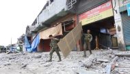 Soldiers walk among debris in Padada town, Davao del Sur province on the southern island of Mindanao on December 16, 2019, following a 6.8-magnitude earthquake on December 15. AFP / Manman Dejeto