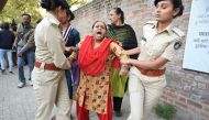 Gujarat Police officials detain a demonstrator during a peaceful protest against the Indian government's Citizenship Amendment Bill (CAB) outside Indian Institute of Management (IIM) in Ahmedabad on December 16, 2019.  AFP / Sam Panthaky 