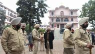 Punjab Police Personnel stand guard as parents of school children protest after a eight-year-old girl was allegedly raped by a school boy, at the Sacred Heart Convent School in Beas, some 55 km from Amritsar on December 16, 2019. AFP / Narinder Nanu
 
