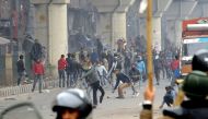 Demonstrators clash with police officers during a protest against a new citizenship law in Seelampur area of Delhi, India on December 17, 2019. (Imtiyaz Khan/Anadolu Agency)
 