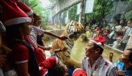 Children react as a Bengal tiger licks the glass surrounding its enclosure during the 