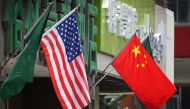 This file photo taken on May 14, 2019 shows the US and Chinese flags displayed outside a hotel in Beijing. AFP / Greg Baker