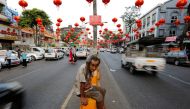 FILE PHOTO: A man sits under lanterns and decorations on a street ahead of the Chinese Lunar New Year in Chinatown, Yangon, Myanmar. January 23, 2017. Reuters / Soe Zeya Tun