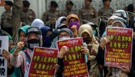 Indonesian hardline Muslim group members take part in an anti-China rally in front of the Chinese colsulate in Surabaya, East Java, on December 27, 2019, to condemn China's government for rounding up an estimated one million Uighurs and other mostly Musli