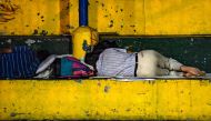 Venezuelan migrants sleep at a park in Bucaramanga, Colombia, on December 17, 2019.  AFP / Juan Barreto 