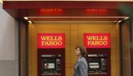 A woman walks past teller machines at a Wells Fargo bank in San Francisco in this October 10, 2013 file photo. Reuters / Robert Galbraith