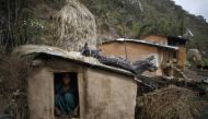 In this 2014 archive photo, a 14-year old girl sits inside a Chaupadi shed in the hills of Legudsen village in Achham District in western Nepal. Reuters / Navesh Chitrakar