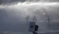 Riot police spray water to disperse demonstrators during a protest against Chilean President Sebastian Pinera's government in Santiago, on December 27, 2019.  AFP / CLAUDIO REYES
