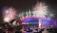 New Year's Eve fireworks erupt over Sydney's iconic Harbour Bridge and Opera House (L) during the fireworks show on January 1, 2020. AFP / Peter Parks
 