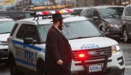 An NYPD car patrols in South Williamsburg Brooklyn on December 30, 2019 in New York City, two days after an intruder wounded five people at a rabbi's house in New York during a gathering to celebrate the Jewish festival of Hanukkah.  AFP / Kena Betancur
