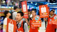 Employees carry banners informing customers about the ban on free single-use plastic bags at a shopping mall in downtown Bangkok on January 2, 2020. Thai retailers kicked off 2020 with a ban on free plastic bags to customers, as an environment group on Ja