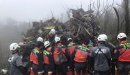 This handout picture released by the Yilan County Fire Department on January 2, 2020, shows rescuers searching for survivors after a military Black Hawk helicopter smashed into mountains in Yilan county near Taipei. AFP / Yilan County Fire Department