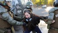 A demonstrator reacts as she is detained by riot policemen during a protest against Chile government in Santiago, Chile, November 30, 2019. Reuters / Pablo Sanhueza