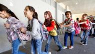 Syrian refugee children queue as they head towards their classroom at a school in Mount Lebanon, October 7, 2016. Reuters / Mohamed Azakir