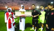 An Al Duhail fan presenting a sword as a welcoming gift to Mario Mandzukic during a training session in Doha yesterday.