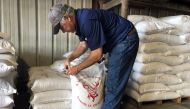 Raymond Schexnayder Jr, a soybean farmer, closes a bag of soybeans from his farm outside Baton Rouge in Erwinville, Louisiana, July 9, 2018. Reuters / Aleksandra Michalska