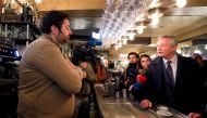 French Finance Minister Bruno Le Maire talks in a cafe as he visits shopkeepers, restaurateurs and hotel operators to assess the economic impact of nationwide strikes on pensions reform in Paris, France, January 3, 2020. Reuters/Charles Platiau 
