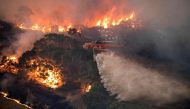 A handout photo taken and received on December 31, 2019 from the State Government of Victoria shows a helicopter fighting a bushfire near Bairnsdale in Victoria's East Gippsland region.  