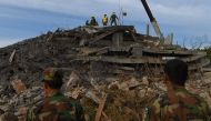 Rescue personnel work at the site where an under-construction building on January 3 collapsed, trapping and killing workers, in southern Cambodia's coastal Kep province on January 4, 2020. Hundreds of soldiers and rescuers frantically picked through the r
