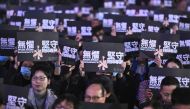 Teachers and pro-democracy supporters hold placards as they take part in a rally to support teachers at Edinburgh Place in the Central district of Hong Kong on January 3, 2020. AFP / Philip Fong