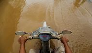 A man rides a motorbike through the mud after floods hit a residential area in Bekasi, West Java province, Indonesia, January 3, 2020. REUTERS/Willy Kurniawan