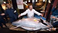 Kiyoshi Kimura (C), President of Kiyomura Corp., the Tokyo-based operator of sushi restaurant chain Sushizanmai, displays a 276-kilogram bluefin tuna that fetched 193.2 million yen (1.8 million USD) at his main restaurant in Tokyo on January 5, 2020 after