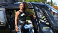 Tennis player Naomi Osaka of Japan poses for photos after a sightseeing ride in a helicopter at the Queensland Tennis Centre in Brisbane on January 2, 2020, ahead of the Brisbane International tennis tournament starting on January 6. AFP / Saeed Khan 