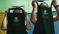 Workers show Starbucks aprons at a dormitory near a factory in Mae Sot district, Thailand in August 2019. Thomson Reuters Foundation / Nanchanok Wongsamuth