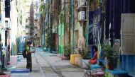 Visitors taking pictures at one of the back alleys that have been upgraded with the help of Doh Eain in downtown Yangon, Myanmar, on Nov 1, 2019. Thomson Reuters Foundation/Thin Lei Win
