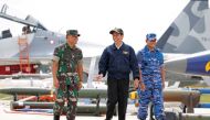 Indonesia's President Joko Widodo (C) along with Military Chief Gatot Nurmantyo (L) and Air Force Commander Agus Supriatna walk past fighter jets and weapons during a military exercise on Natuna Island, Riau Islands province, Indonesia October 6, 2016. RE
