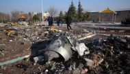 Rescue teams work amidst debris after a Ukrainian plane carrying 176 passengers crashed near Imam Khomeini airport in the Iranian capital Tehran early in the morning on January 8, 2020, killing everyone on board.  AFP 