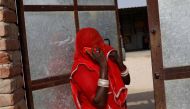 A woman speaks on the phone outside her house in a village in Jalore, India, April 11, 2018. Reuters/Danish Siddiqui