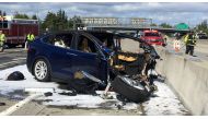 Rescue workers attend the scene where a Tesla electric SUV crashed into a barrier on US Highway 101 in Mountain View, California, March 25, 2018. (KTVU / Fox 2 via Reuters) 