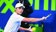 Serbian Miomir Kecmanovic returns a shot to Hungarian qualifier Marton Fucsovics during their quarter-final match of the Qatar ExxonMobil Open 2020 at the Khalifa International Tennis and Squash Complex in Doha yesterday. Pic: Salim Matramkot / The Penins